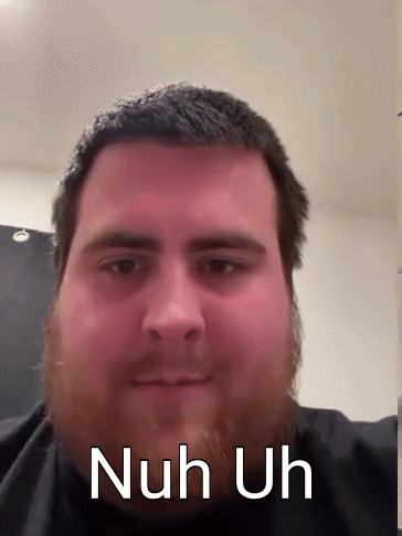 A Man With A Beard Is Looking At The Camera With The Words Nuh Uh Written On His Face . GIF