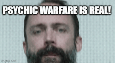 A Man With A Beard Is Looking At The Camera With The Words `` Psychic Warfare Is Real '' Written Below Him . GIF