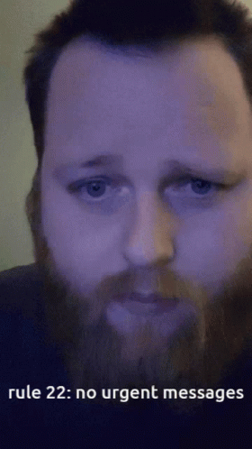 A Man With A Beard Is Looking At The Camera With The Words Rule 22 : No Urgent Messages Below Him GIF