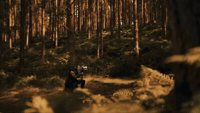 A Man With A Beard Is Looking Down At Something GIF