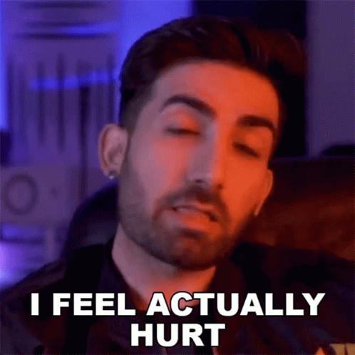 A Man With A Beard Is Making A Funny Face And Saying `` I Feel Actually Hurt '' With His Eyes Closed . GIF