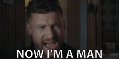 A Man With A Beard Is Making A Funny Face And Says `` Now I 'M A Man '' . GIF