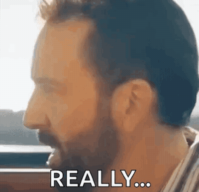 A Man With A Beard Is Making A Funny Face And Says `` Really '' . GIF