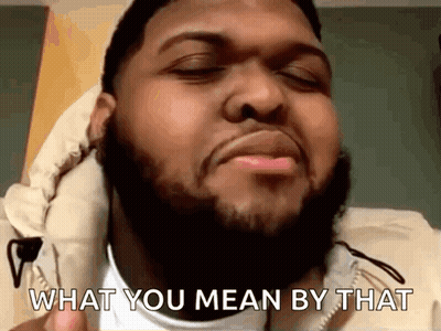 A Man With A Beard Is Making A Funny Face And Says What You Mean By That GIF