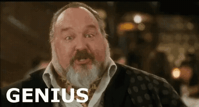 A Man With A Beard Is Making A Funny Face And The Word Genius Is On The Screen . GIF