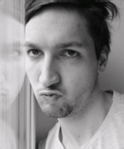 A Man With A Beard Is Making A Funny Face In A Black And White Photo GIF
