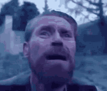 A Man With A Beard Is Making A Funny Face In A Blurry Photo GIF