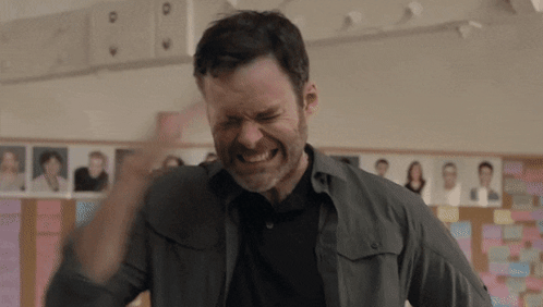 Bearded Man Making Funny Face In Front Of Bulletin Board GIF