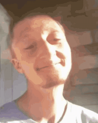 A Man With A Beard Is Making A Funny Face With His Eyes Closed And His Mouth Open . GIF