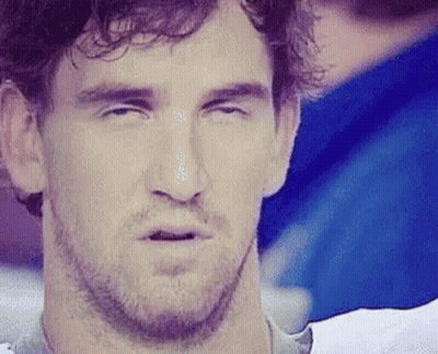 A Man With A Beard Is Making A Funny Face With His Eyes Closed And His Mouth Open . GIF