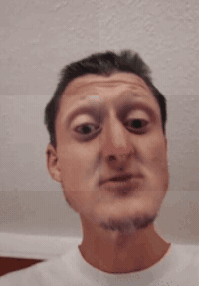 A Man With A Beard Is Making A Funny Face With His Eyes Closed GIF