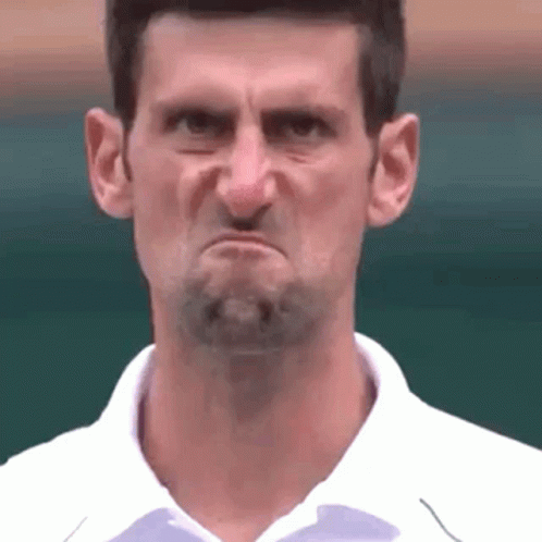 A Man With A Beard Is Making A Funny Face With His Mouth Open . GIF