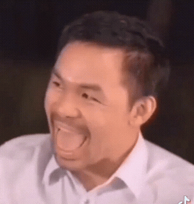 A Man With A Beard Is Making A Funny Face With His Tongue Out . GIF