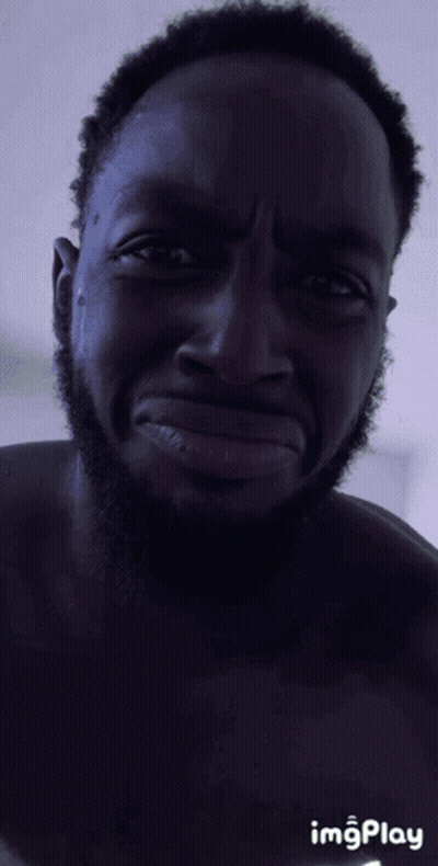 A Man With A Beard Is Making A Funny Face With Imgplay In The Corner GIF