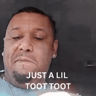 A Man With A Beard Is Making A Funny Face With The Words Just A Lil Toot Toot Above Him . GIF