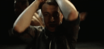 A Man With A Beard Is Making A Hand Gesture With His Hands GIF