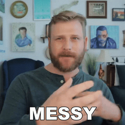 A Man With A Beard Is Making A Messy Gesture With His Hands GIF