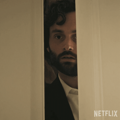A Man With A Beard Is Peeking Out Of A Door That Says Netflix On The Bottom GIF