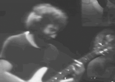 A Man With A Beard Is Playing A Guitar GIF