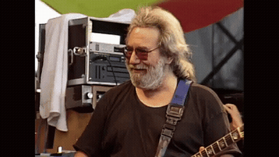 A Man With A Beard Is Playing A Guitar With A Blue Strap GIF