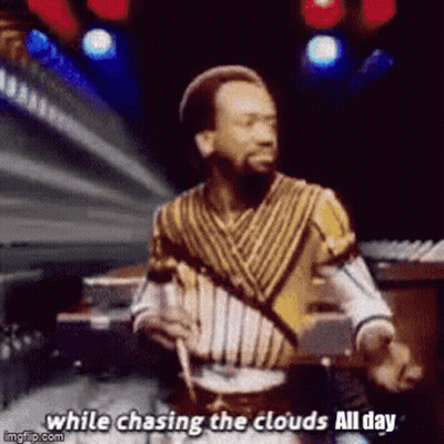 A Man With A Beard Is Playing Drums And Singing While Chasing The Clouds All Day . GIF