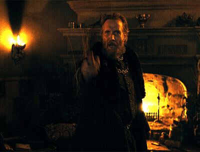 A Man With A Beard Is Pointing A Gun At The Camera GIF