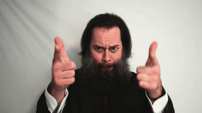 A Man With A Beard Is Pointing At The Camera With Both Hands GIF
