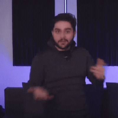 A Man With A Beard Is Pointing His Finger At The Camera . GIF