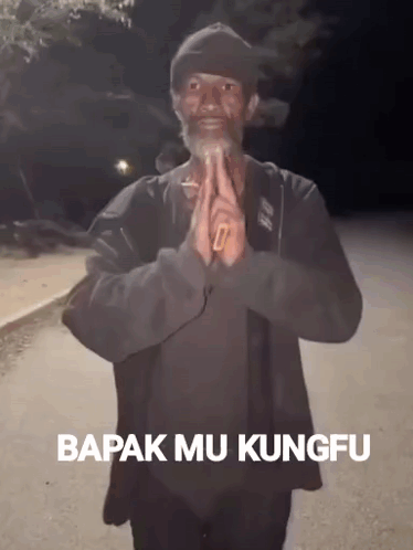 A Man With A Beard Is Praying With The Words Bapak Mu Kungfu On The Bottom Right GIF