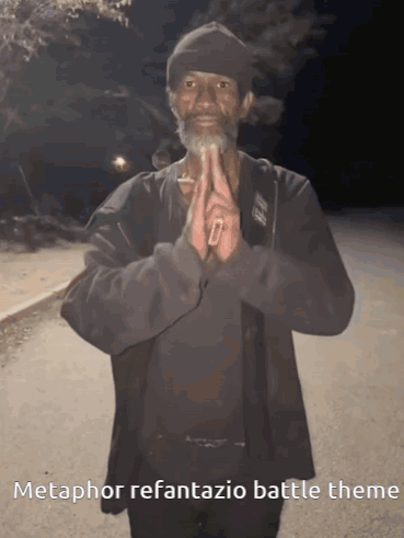 A Man With A Beard Is Praying With The Words Metaphor Refantasia Battle Theme Written Below Him GIF