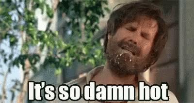 A Man With A Beard Is Saying `` It 'S So Damn Hot '' While Eating A Donut . GIF