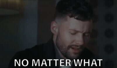 A Man With A Beard Is Saying No Matter What In A Dark Room . GIF