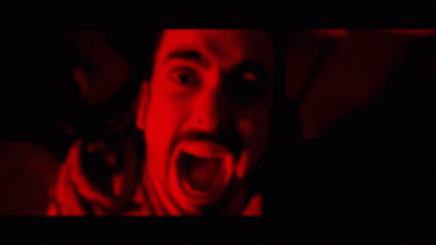 A Man With A Beard Is Screaming In The Dark GIF