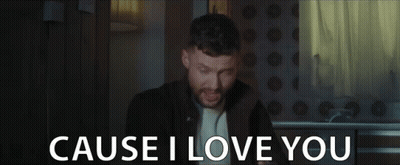 A Man With A Beard Is Singing In A Dark Room And The Words `` Cause I Love You '' Are Behind Him . GIF