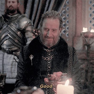 A Man With A Beard Is Sitting At A Table With A Candle And Says " Good " GIF