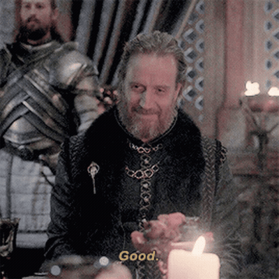A Man With A Beard Is Sitting At A Table With A Candle And Says " Good " GIF