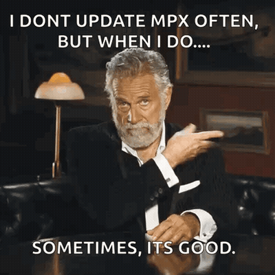 A Man With A Beard Is Sitting At A Table With A Caption That Says I Dont Update Mpx Often But GIF