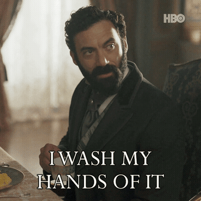 A Man With A Beard Is Sitting At A Table With A Cup Of Coffee And Says I Wash My Hands Of It GIF