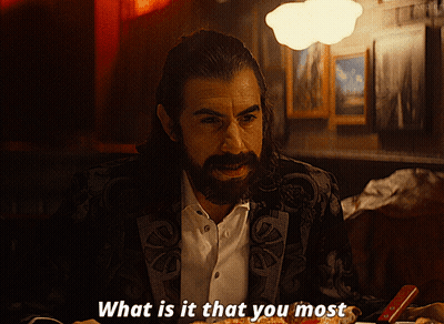 A Man With A Beard Is Sitting At A Table With A Plate Of Food And Says What Is It That You Most GIF