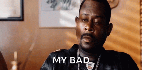 A Man With A Beard Is Sitting At A Table With His Eyes Closed And The Words `` My Bad '' Written On The Screen . GIF