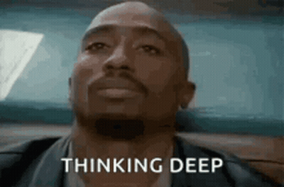 A Man With A Beard Is Sitting In A Car And Thinking Deep . GIF