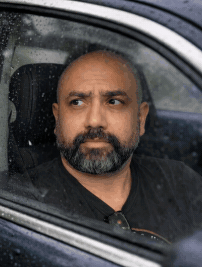 A Man With A Beard Is Sitting In A Car GIF