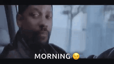 A Man With A Beard Is Sitting In A Car With The Word Morning Written Above Him . GIF