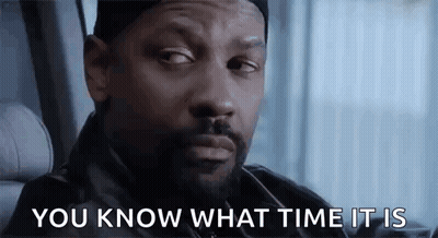 A Man With A Beard Is Sitting In A Car With The Words `` You Know What Time It Is '' Written On His Face . GIF
