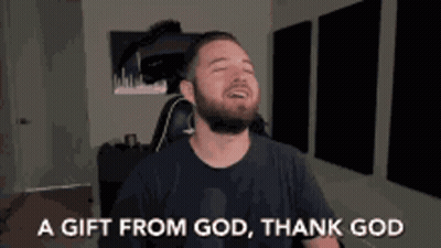 A Man With A Beard Is Sitting In A Chair With His Eyes Closed And Says A Gift From God Thank God GIF