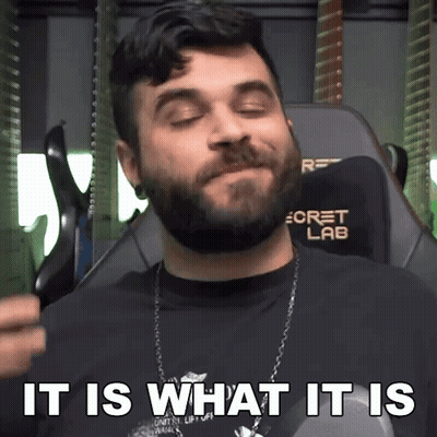 A Man With A Beard Is Sitting In A Chair With The Words " It Is What It Is " Above Him GIF