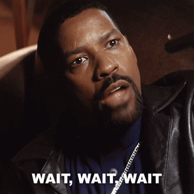 A Man With A Beard Is Sitting In A Chair With The Words Wait Wait Wait Written On The Bottom GIF