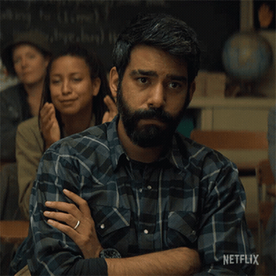A Man With A Beard Is Sitting In A Classroom With Netflix Written On The Bottom Of The Image GIF