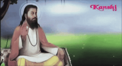 A Man With A Beard Is Sitting In A Field With Kanshi Written In The Corner GIF
