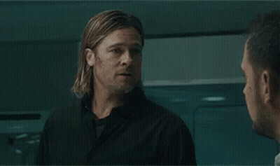 A Man With A Beard Is Sitting In A Laboratory Looking At Something . GIF